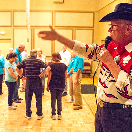 Square dancing, showing Caller
